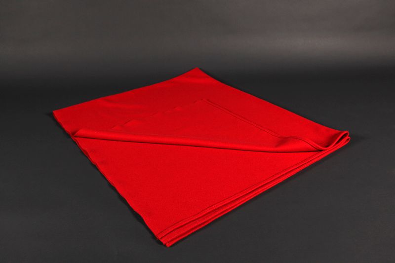 A red woolen blanket folded back.