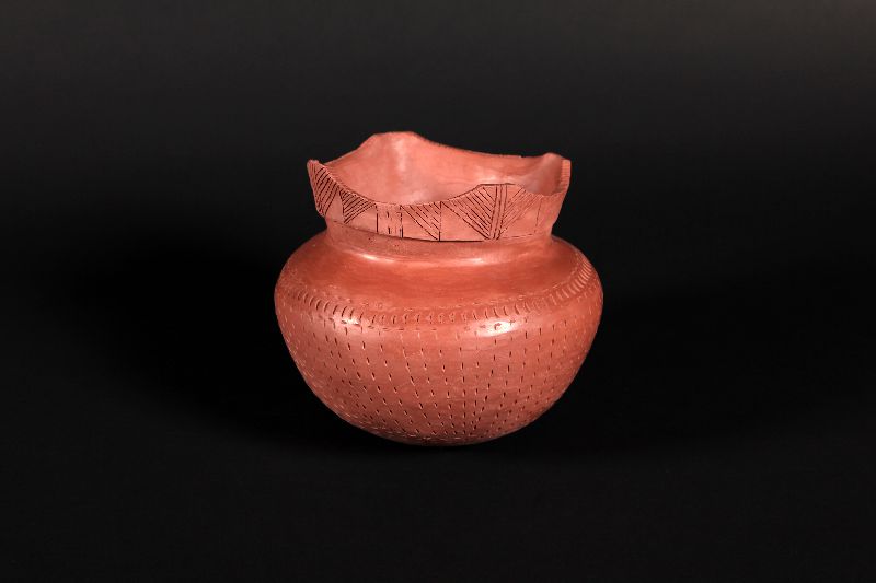 This small clay pot is decorated with motifs made of dots and lines.